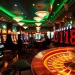 Experience the thrilling atmosphere of C168 casino gaming with vibrant slot machines and intense poker action at night.
